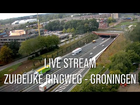 Live view of Stationsweg street with trams and cyclists in Groningen, Netherlands