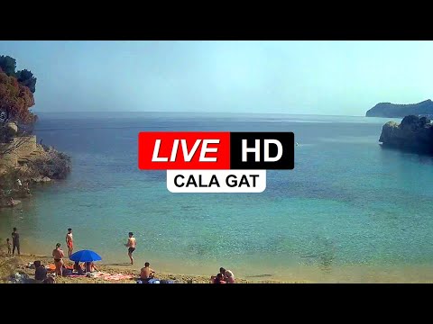 Live view of Playa de Muro beach with turquoise waters and golden sands in the Balearic Islands, Spain