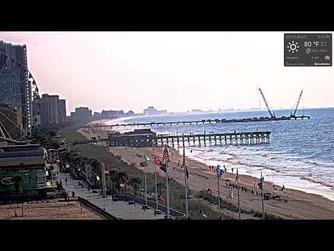 Live view of Myrtle Beach Boardwalk with ocean and visitors in South Carolina